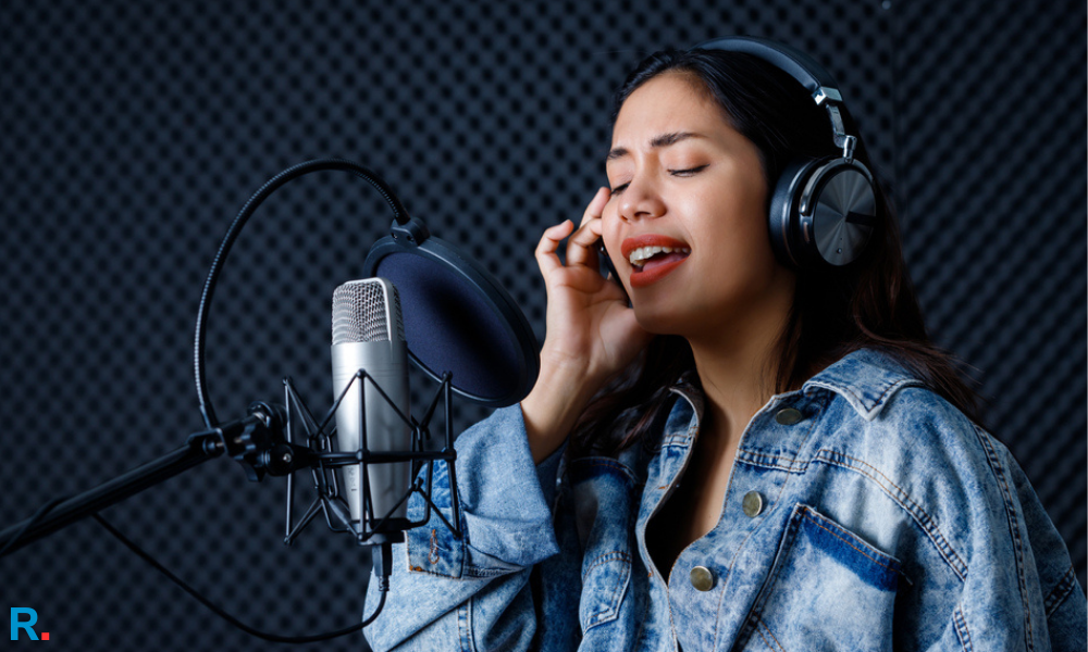 singer siwomen singing a song using best studio headphones in india in a sound mixing studio